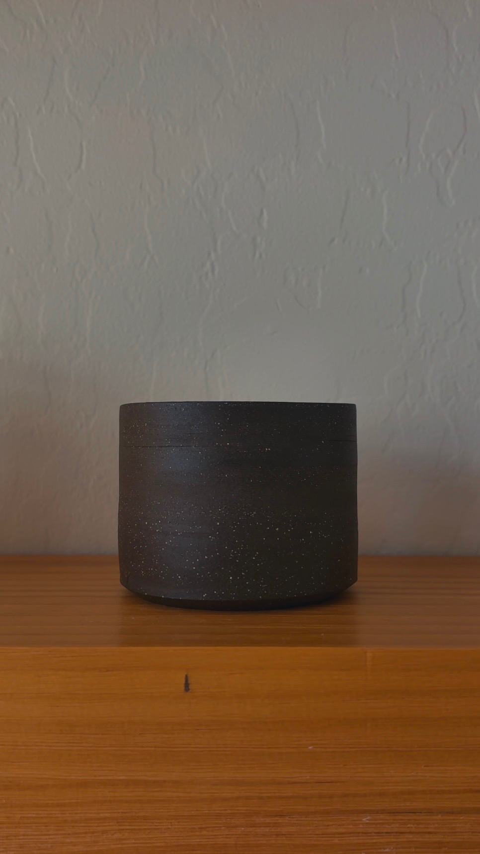 Dark stoneware vessel, front view