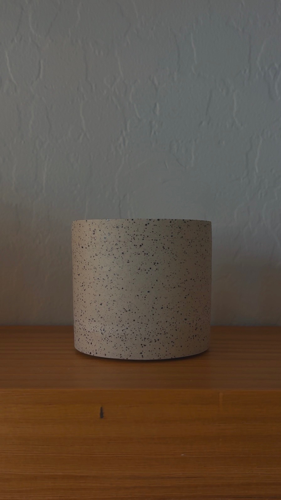 Light speckled stoneware vessel, front view